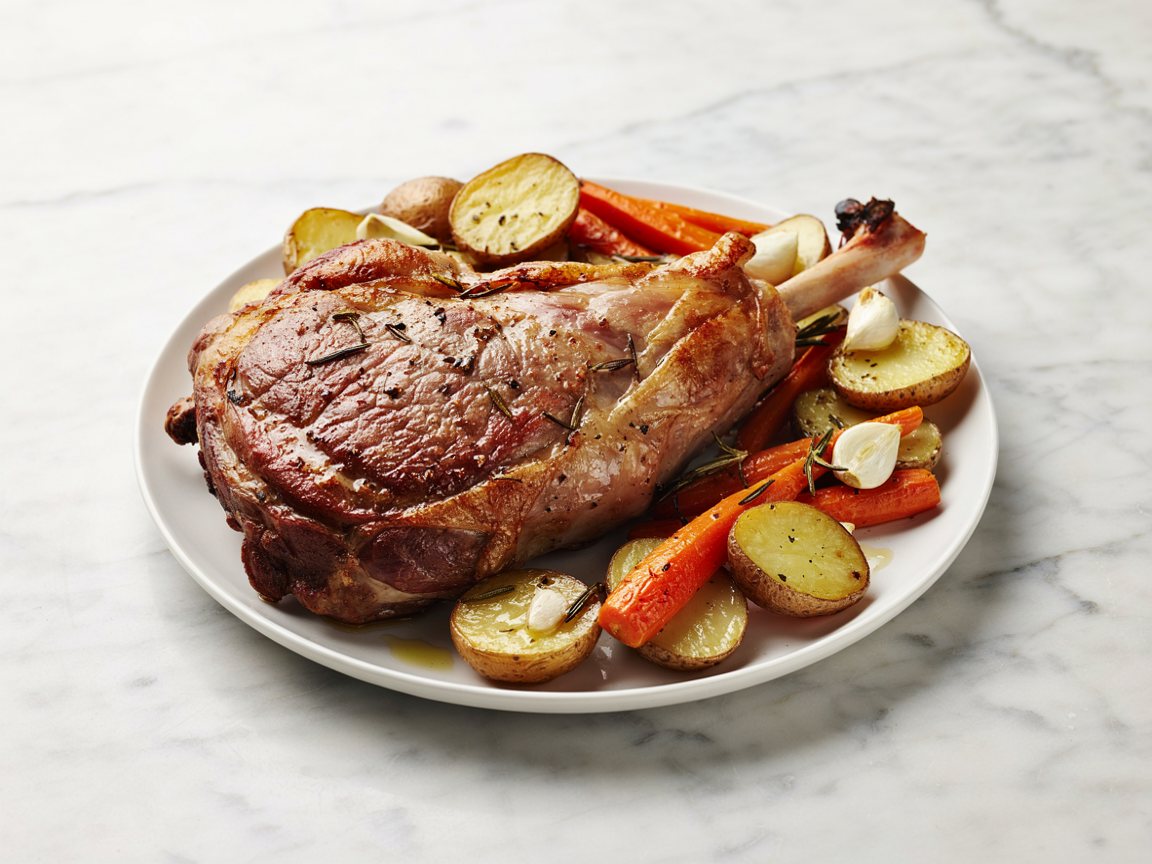 Photo of Easter Sheet-Pan Leg of Lamb with Potatoes and Carrots